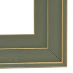 Close-up of the frame's lower right corner, showing the layered green-grey surfaces, fine gold-tone edge lines and diagonal corner joins.