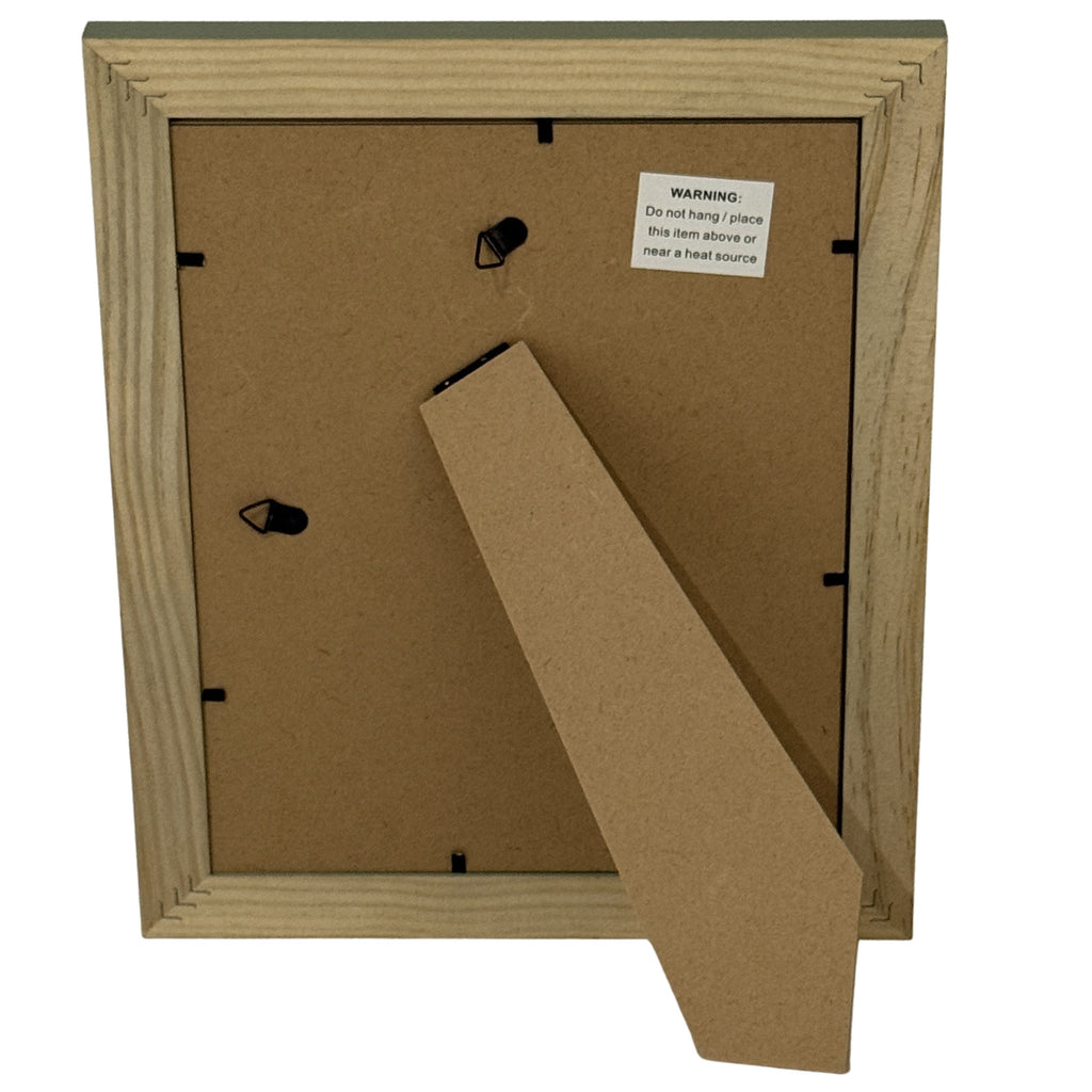Reverse of the photo frame with a brown panel, extended easel, black fittings and a warning label instructing not to hang or place the item above or near a heat source.