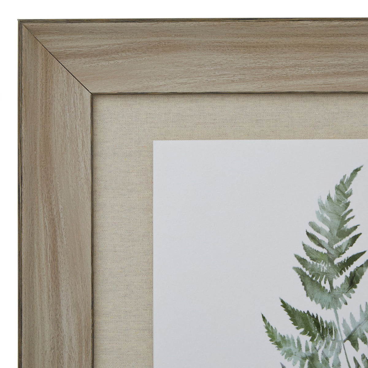 Close-up of the artwork's upper-left frame corner, showing its wood-grain appearance, beige woven-looking surround and the tip of a green fern frond.