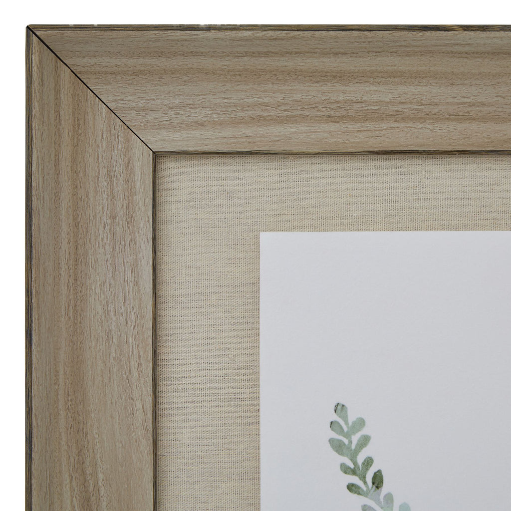Close-up of the frame's upper left mitred corner, showing brown grain-like markings beside the finely textured beige surround.