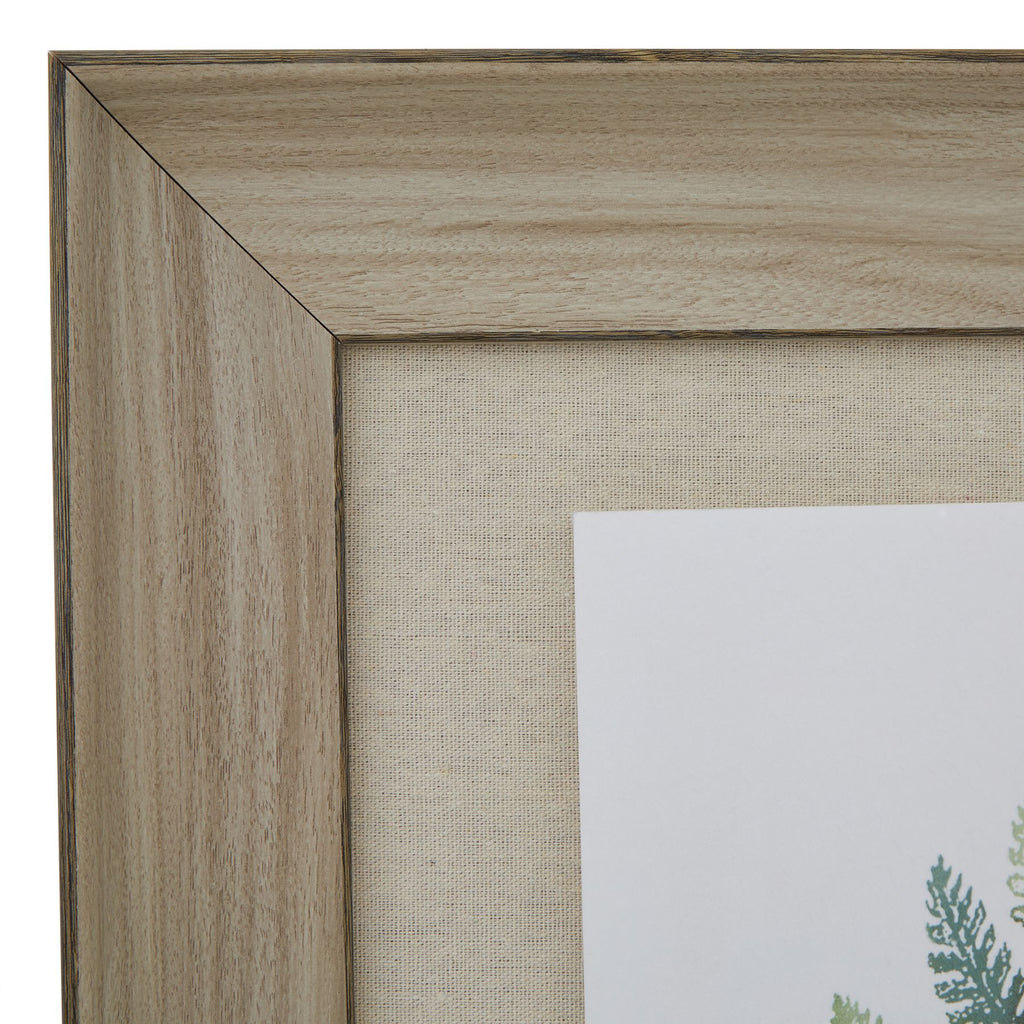 Close-up of the upper left mitred frame corner, showing pale grain-like markings, dark edging and the beige mount's woven appearance.