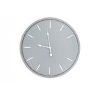 Front view of a round grey wall clock with white baton hour markers and shaped white hands.