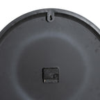Rear view of the clock showing its dark back, quartz mechanism and keyhole hanging tab.