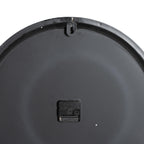 Rear view of the clock showing its dark circular back, central black movement and keyhole-shaped hanging tab at the top.