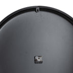 Rear view of the clock showing its dark circular back, small central movement and keyhole-shaped hanging tab near the top rim.