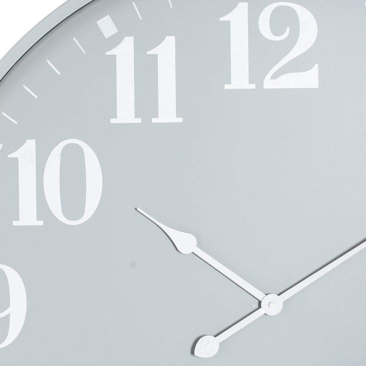 Close-up of the grey clock face showing the white 10, 11 and 12 numerals, fine minute marks and shaped white hands.
