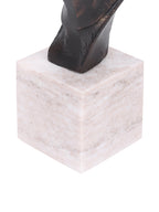 Close-up of the sculpture’s dark lower neck and pale marble block base with subtle tonal markings.