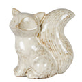 Glossy cream-white seated fox ornament looking left, with upright ears, rounded paws and a large grooved tail curling upwards against a white background.