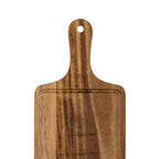 Close-up of the board's rounded handle and sweeping shoulders, showing the hanging hole, recessed groove and contrasting grain bands.