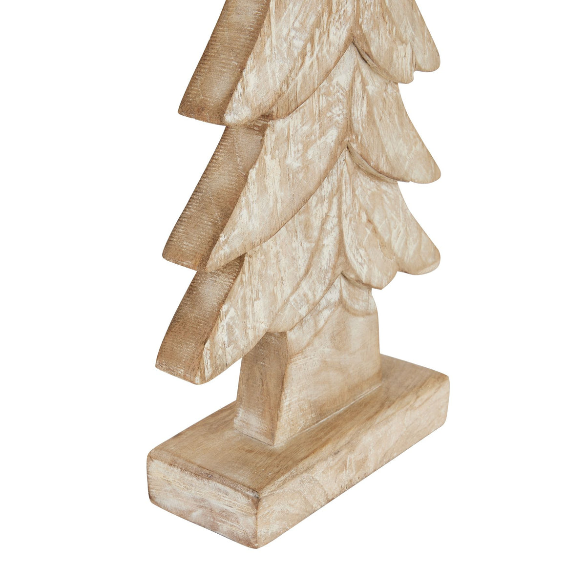 Angled close-up of the tree decoration's lower branches, short trunk and rectangular foot, showing curved grooves and distressed whitewashing.