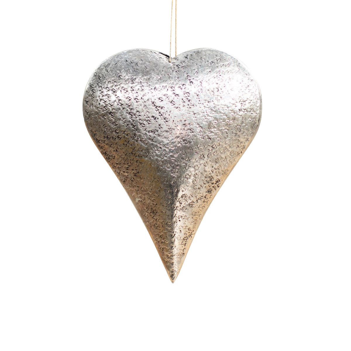 Silver-toned hammered metal heart with rounded shoulders, a long pointed tip and a pale hanging cord, shown against white.
