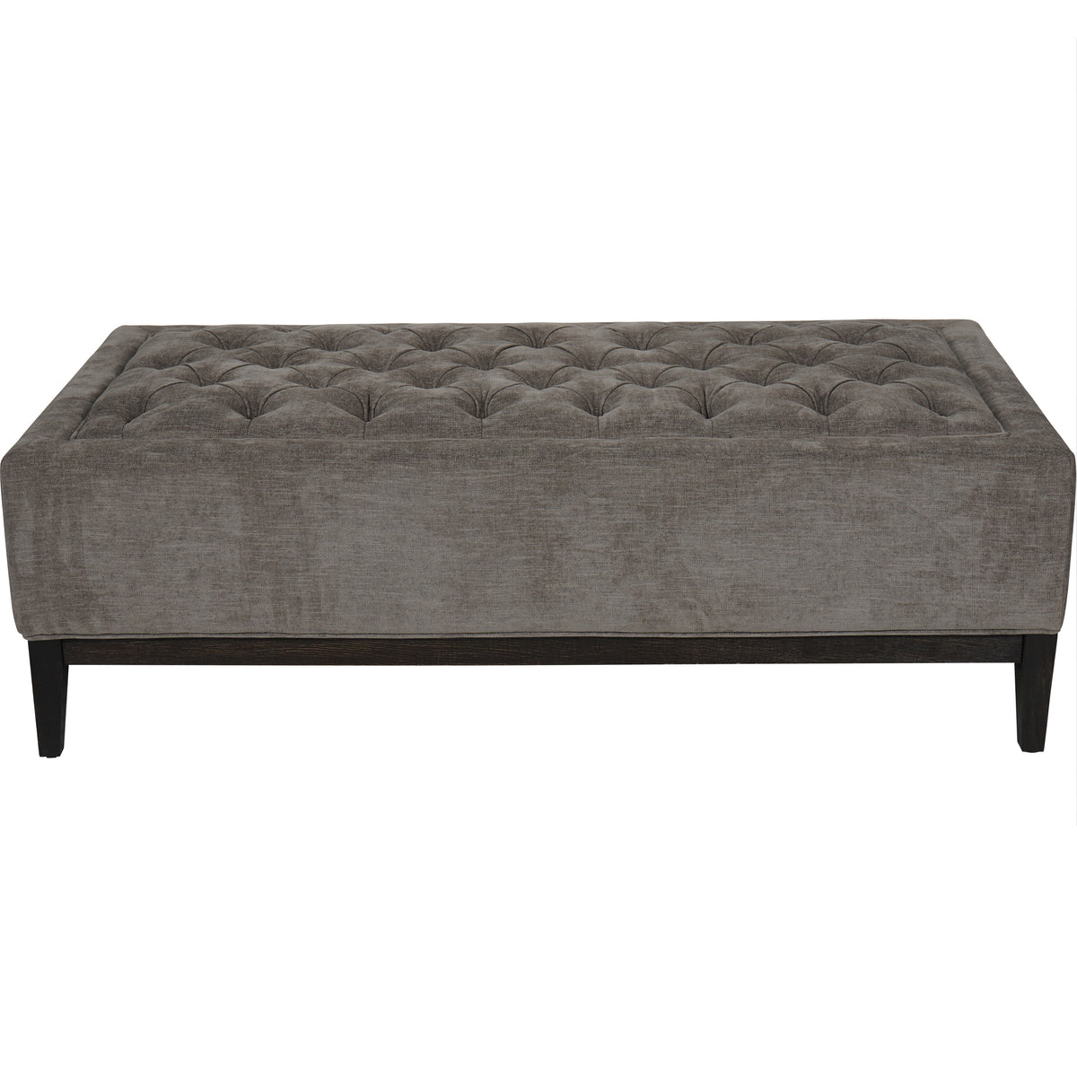 Front view of the warm grey rectangular ottoman, showing its buttoned top, plain upholstered sides and dark wooden legs.
