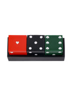 View from above of three dice in a black tray, showing a white heart on red, five white dots on black and six white shamrocks on green.