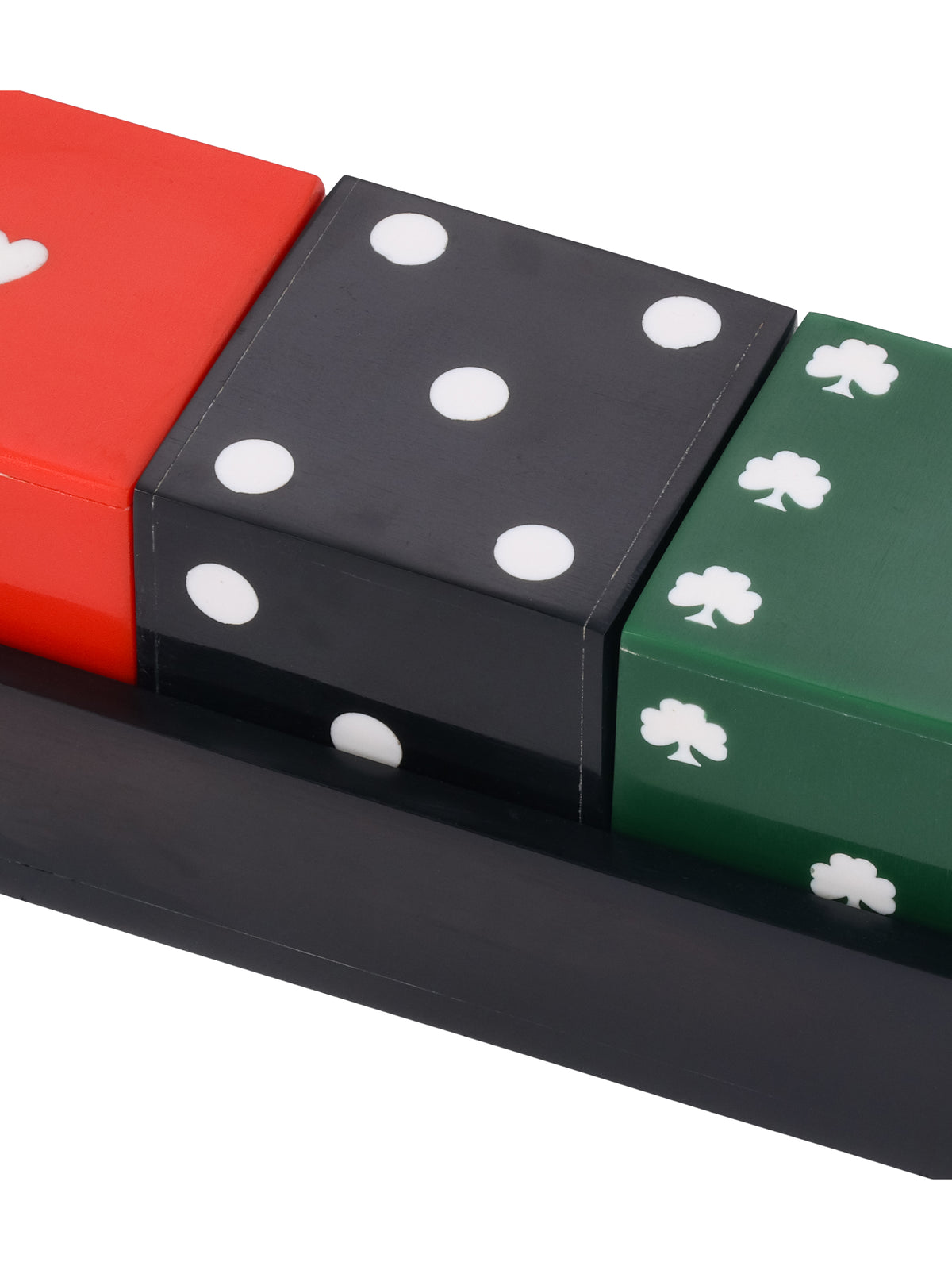 Close-up of the black die with white dots, framed by portions of the red heart and green shamrock dice.