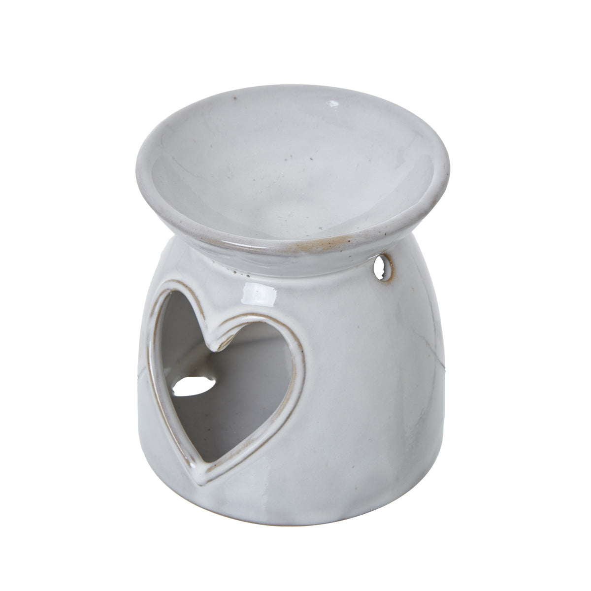 Angled view of the off-white wax burner showing its shallow upper bowl, heart opening and small round side hole.