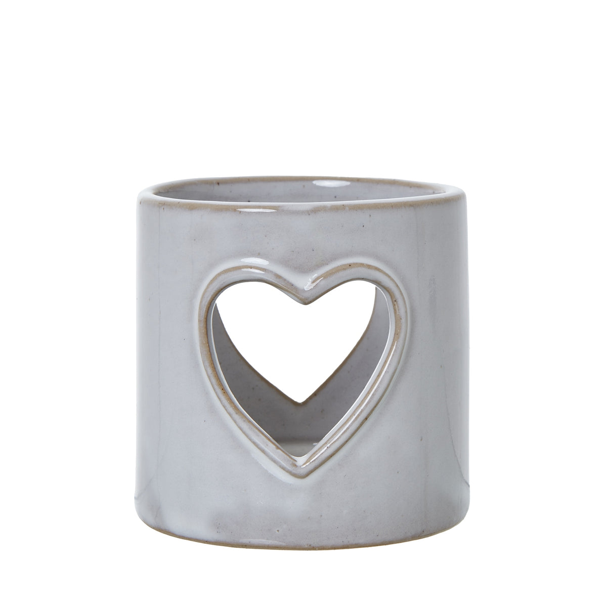 Front view of the off-white cylindrical candle holder, showing a large tan-edged heart opening and glossy speckled surface.