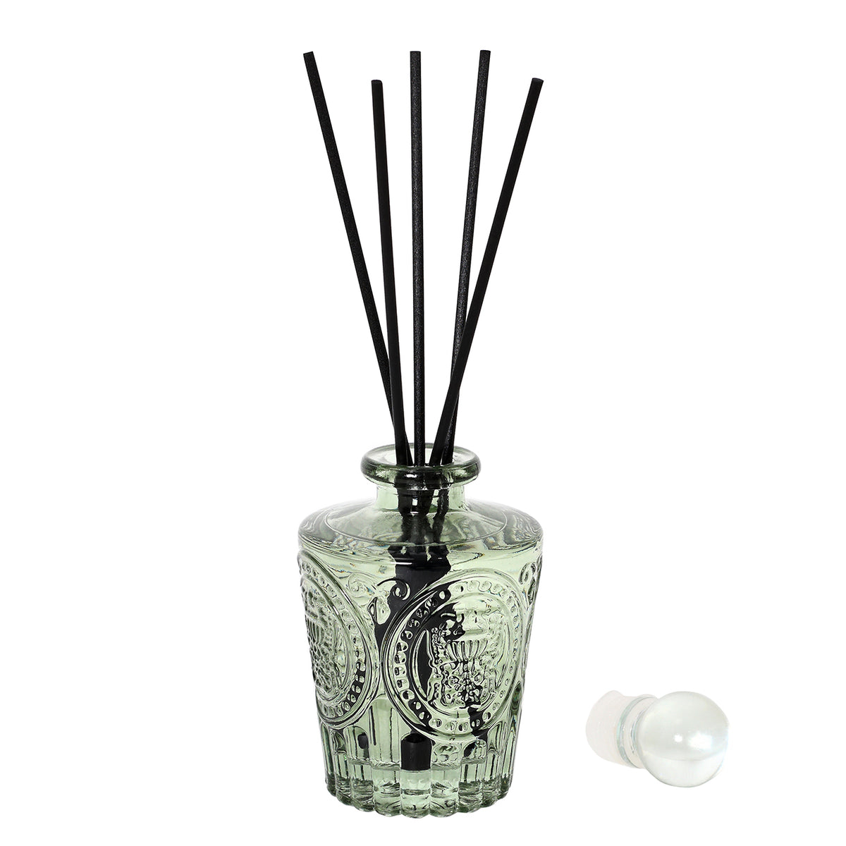 Herbalist diffuser with five black reeds in the open green glass bottle and its spherical stopper lying alongside.