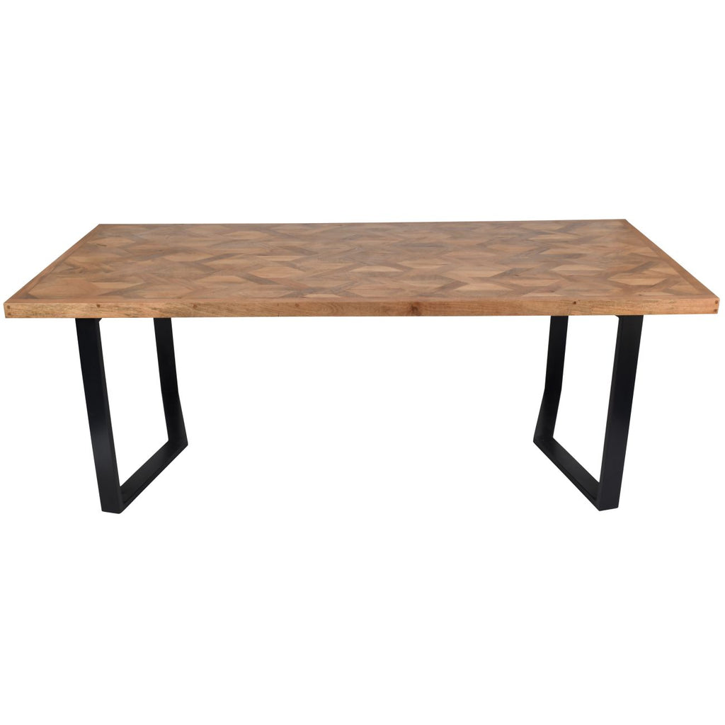 Elevated view of the dining table showing the herringbone wood pattern within a straight border and black metal legs.