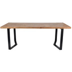Front view along the long side of the wooden dining table, showing its straight edge and open black leg frames.