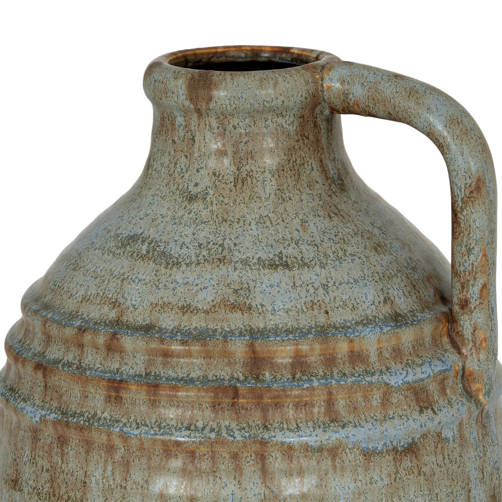 Close-up of the vase's neck and high loop handle, showing fine blue-grey and olive mottling, brown streaks and the raised bands across the shoulder.
