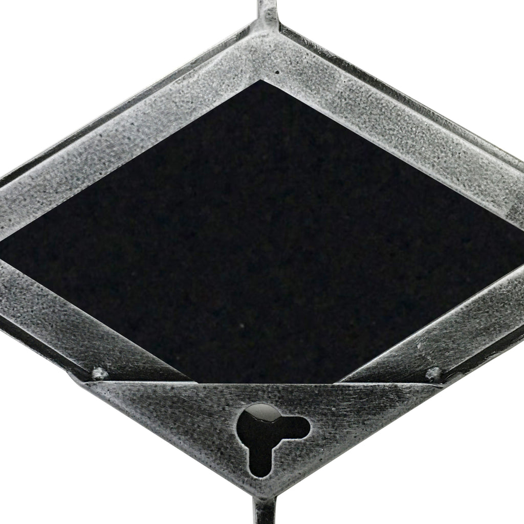 Close-up of a mirror panel's reverse, showing the textured grey metal frame, dark diamond-shaped backing and keyhole opening.