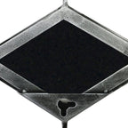 Close-up of a mirror panel's reverse, showing the textured grey metal frame, dark diamond-shaped backing and keyhole opening.