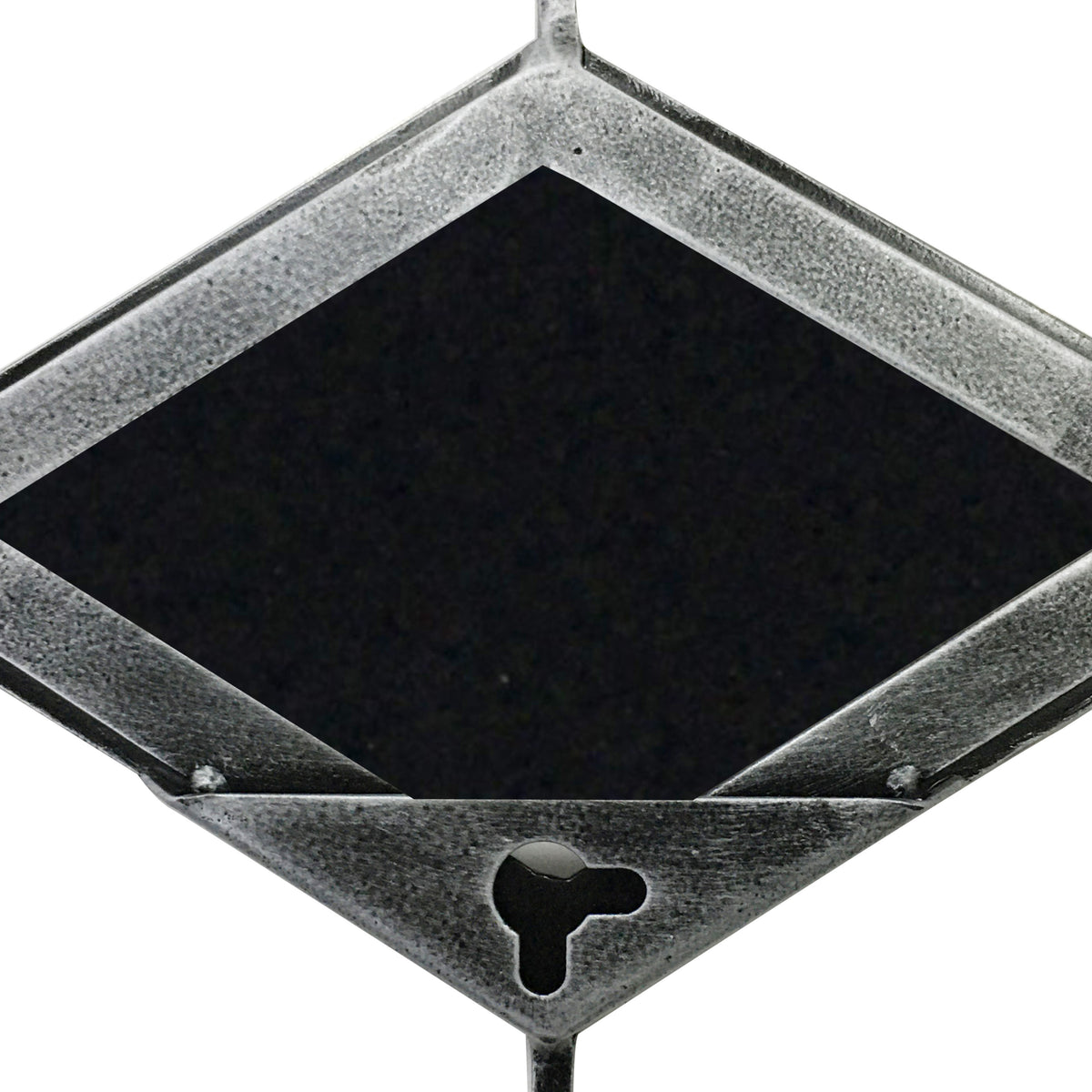 Close-up of a mirror panel's reverse, showing the textured grey metal frame, dark diamond-shaped backing and keyhole opening.