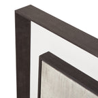 Close-up of the artwork's upper frame corners, showing the streaked dark finish, broad pale mount and textured pale image surface.