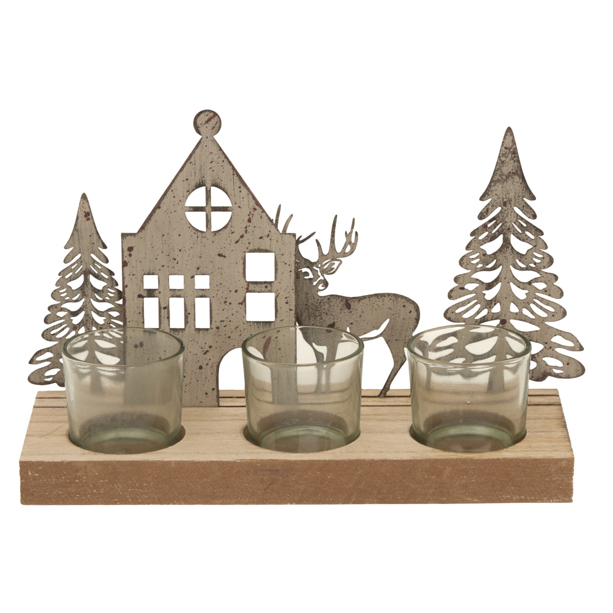 Three smoky votives shown across a rectangular wood base, with a pale weathered house, reindeer and two fir-tree silhouettes behind.