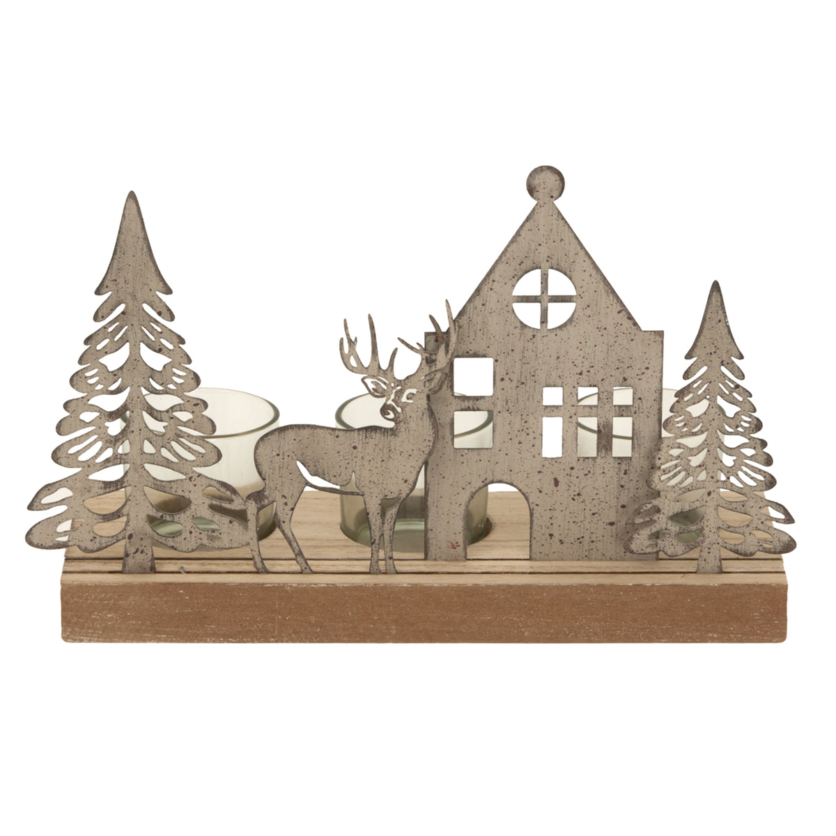 House and reindeer silhouettes between two cut-out fir trees, showing the round roof window and mottled finish, with smoky votives visible behind the scene.