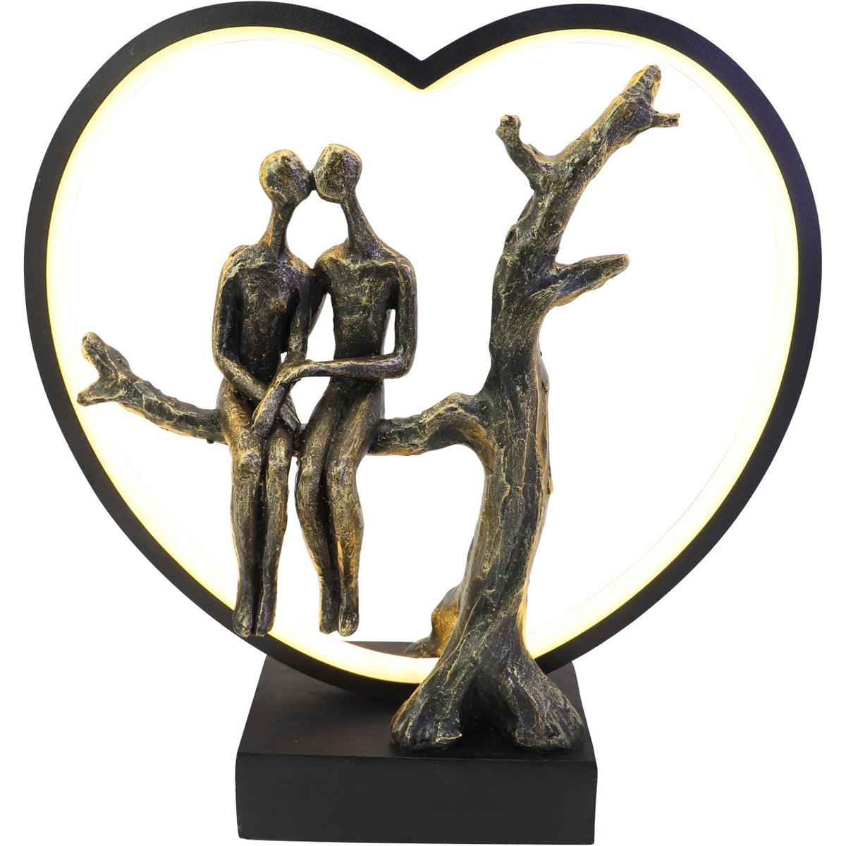 Front view of the sculpture with two figures seated beside a bare tree, enclosed by a glowing heart on a black base.
