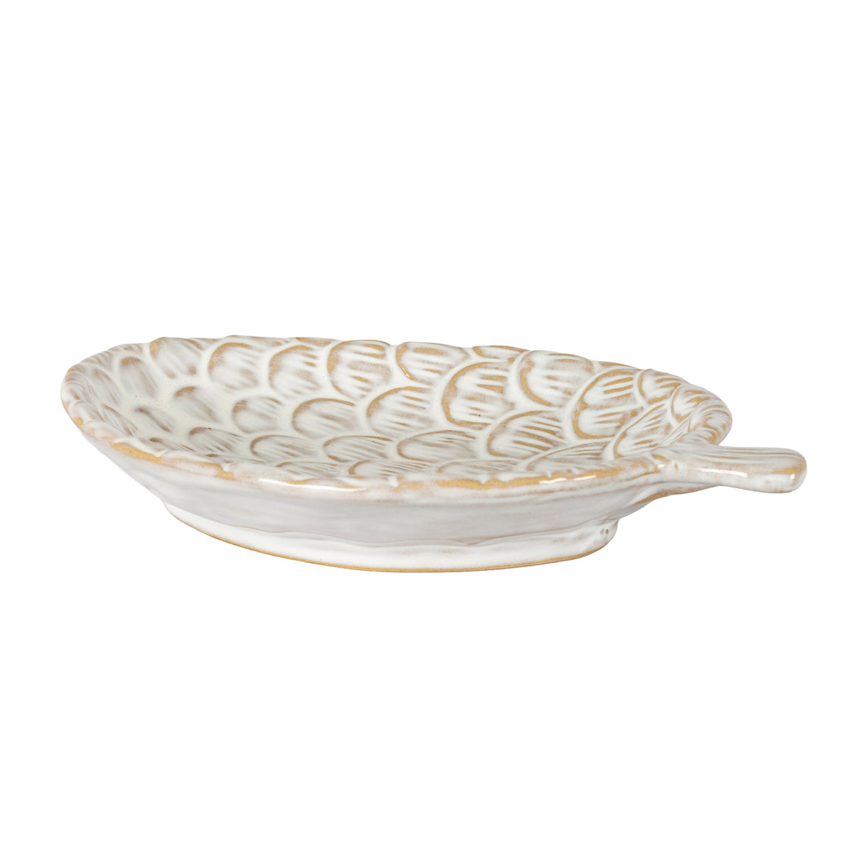Low side view of the cream pinecone dish, showing its shallow bowl, scalloped rim, raised foot and projecting stem on the right.