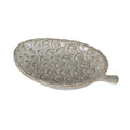 Cream pinecone-shaped decorative dish viewed from above at an angle, showing tan-brown incised scales and a short stem extending to the right.