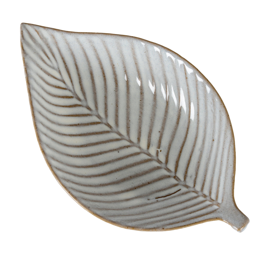Close overhead view of the leaf-shaped dish, with brown-grey veins branching from the central midrib across the speckled off-white interior.