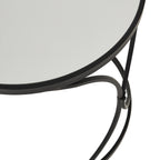 Close view of the mirrored tabletop inside its black rim, with curved supports visible beneath the edge.