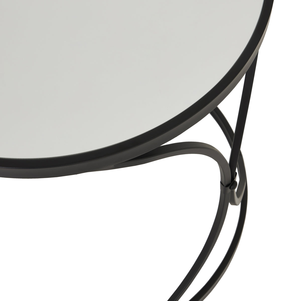 Close view of the mirrored tabletop inside its black rim, with curved supports visible beneath the edge.