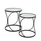 Two round side tables with mirrored tops and black curved frames, with the taller table behind and to the left.