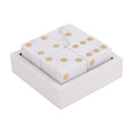 Angled view of four white marble dice with brass-coloured pips arranged in a square marble box.