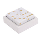 Angled view of four white marble dice with brass-coloured pips arranged in a square marble box.