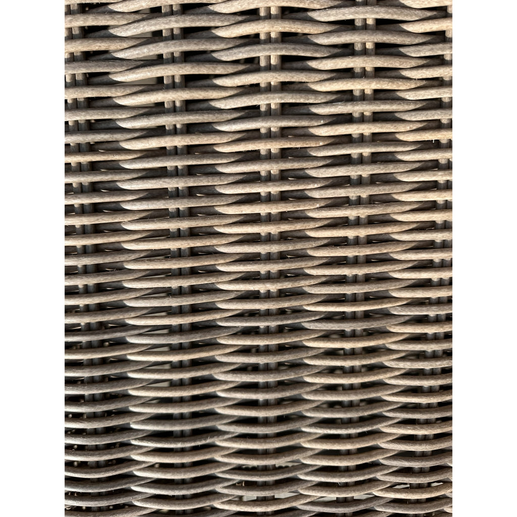 Close-up of grey-beige horizontal woven strands crossing a finer vertical grid, showing subtle variations in colour and texture.