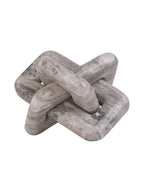 Beige marble knot sculpture shown at an angle, with rounded interlocking loops and mottled grey markings against white.