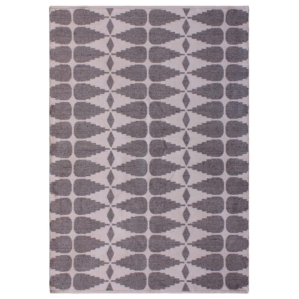 Full view of a rectangular rug with grey stepped geometric shapes and small diamonds against an ivory background.