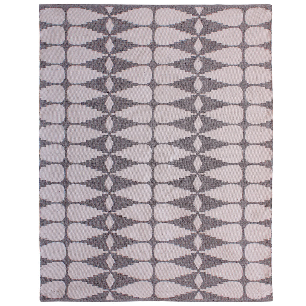 Full view of the rug's reverse, with ivory interlocking shapes and diamonds against a grey background.