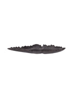 Front view of an elongated black decorative dish with a shallow curved body and uneven raised rim on a white background.