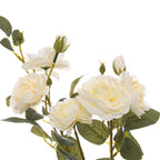 Close-up of layered ivory-white artificial blooms and upright buds among serrated green leaves against a white background.