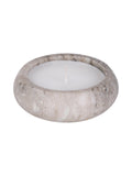 Angled view of a low, rounded beige marble candle with white wax and an unlit wick against a white background.