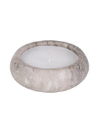 Angled view of a low, rounded beige marble candle with white wax and an unlit wick against a white background.