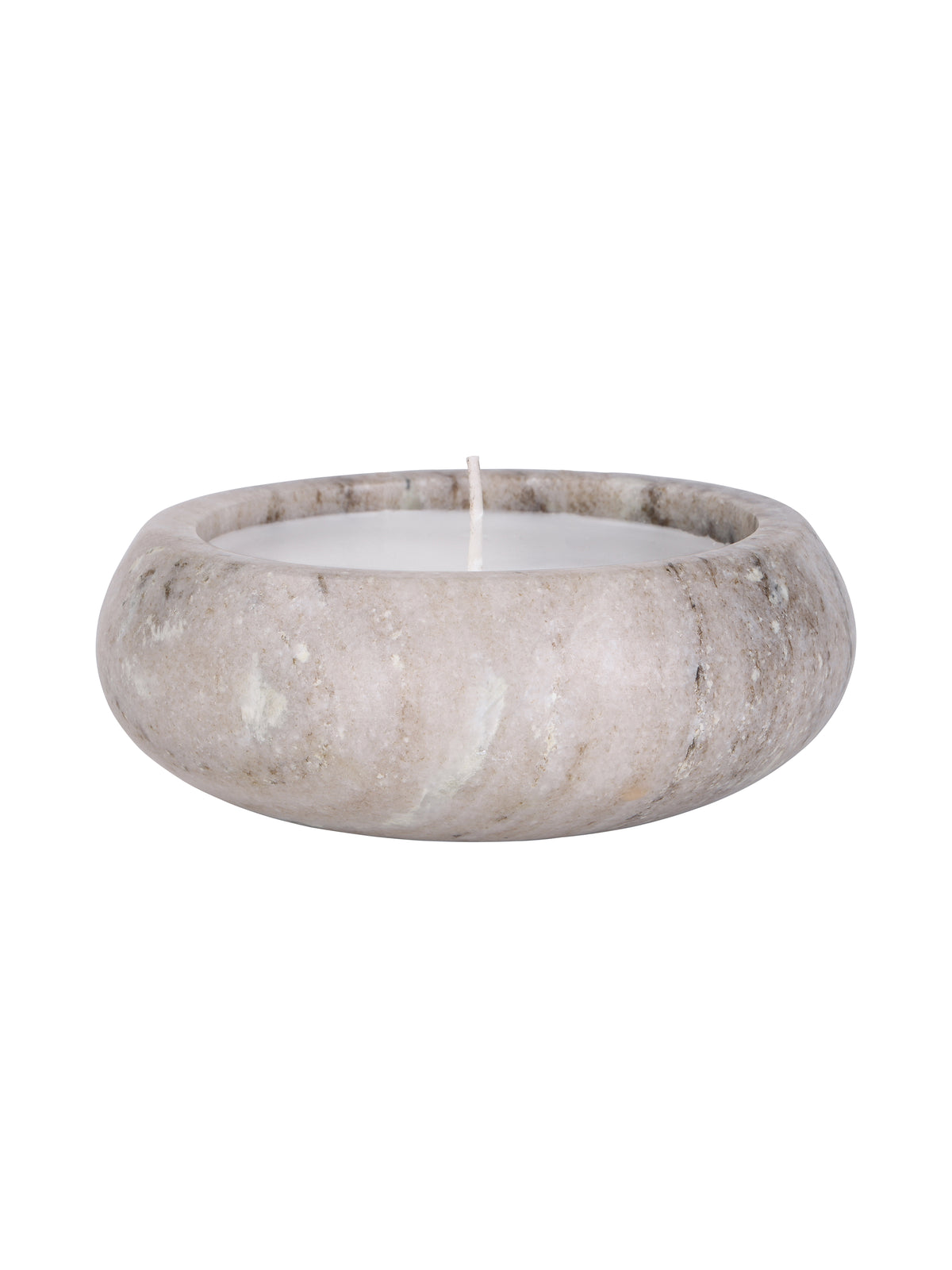 Side view of the beige marble candle, showing its curved body, natural markings and wax below the rounded rim.