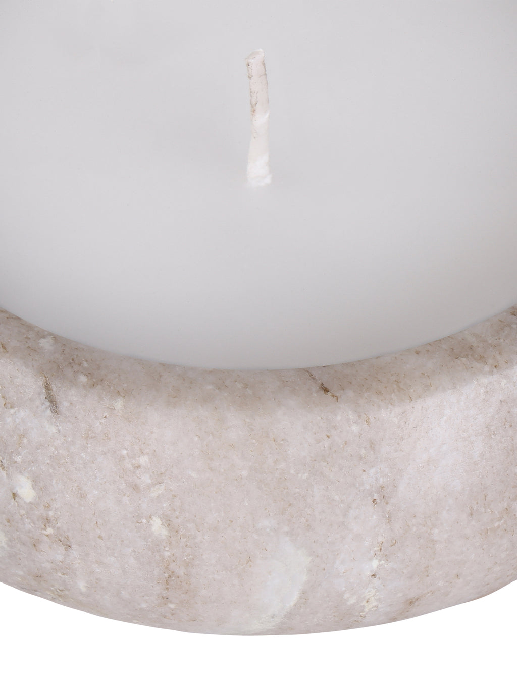 Close-up of the candle's curved marble front and rounded rim beneath the white wax surface and unlit wick.