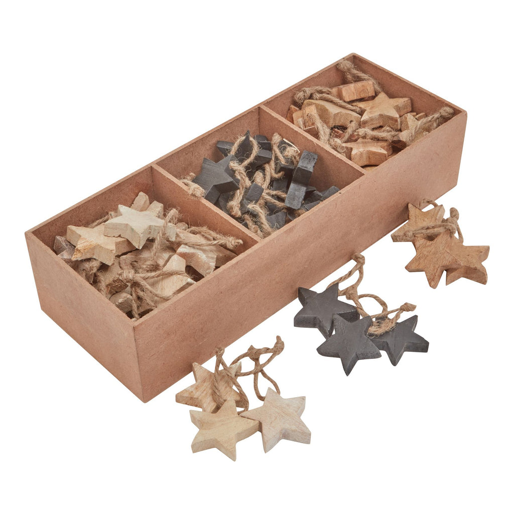 Cream, charcoal and brown hanging stars arranged in three sections of a rectangular tray, with more stars laid in front.